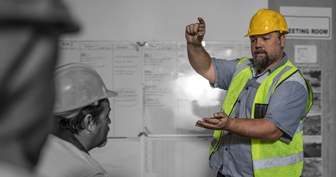 image of a male construction planner-scheduler in front of the screen