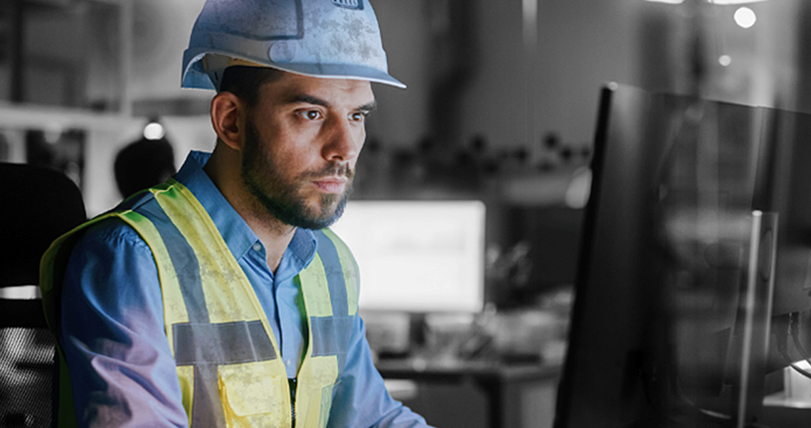 image of a male construction planner-scheduler in front of the computer screen